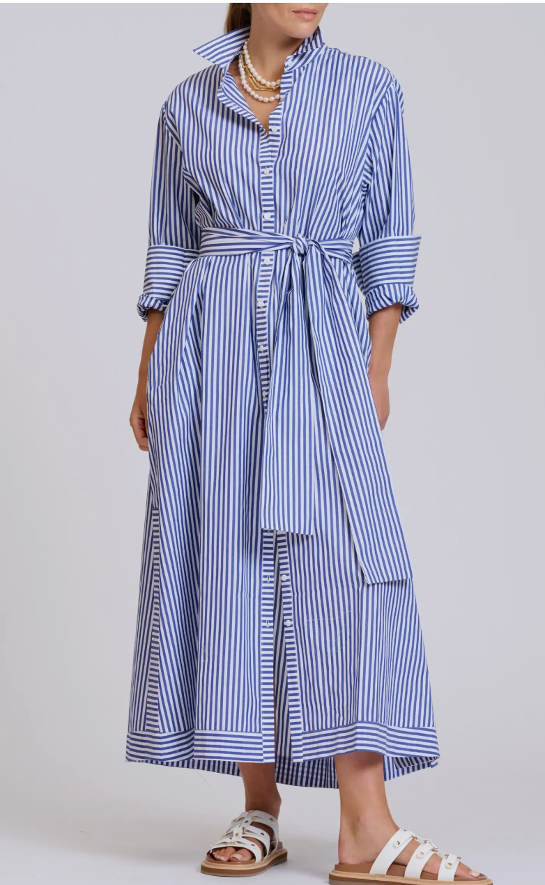 Woman wearing a blue and white striped dress on a plain background