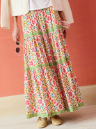 Person wearing a floral skirt with a plain background
