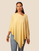 Woman wearing a yellow poncho over a beige background