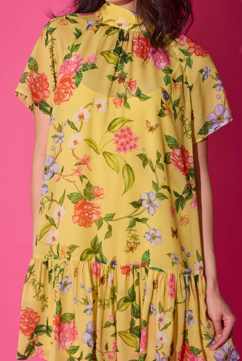 Yellow floral dress on a pink background
