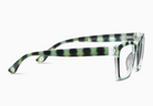 Eyeglasses with striped green and black frame on a white background