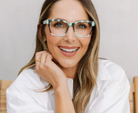 Woman wearing glasses with a neutral background