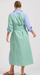 Person wearing a green and white striped dress with a belt on a white background