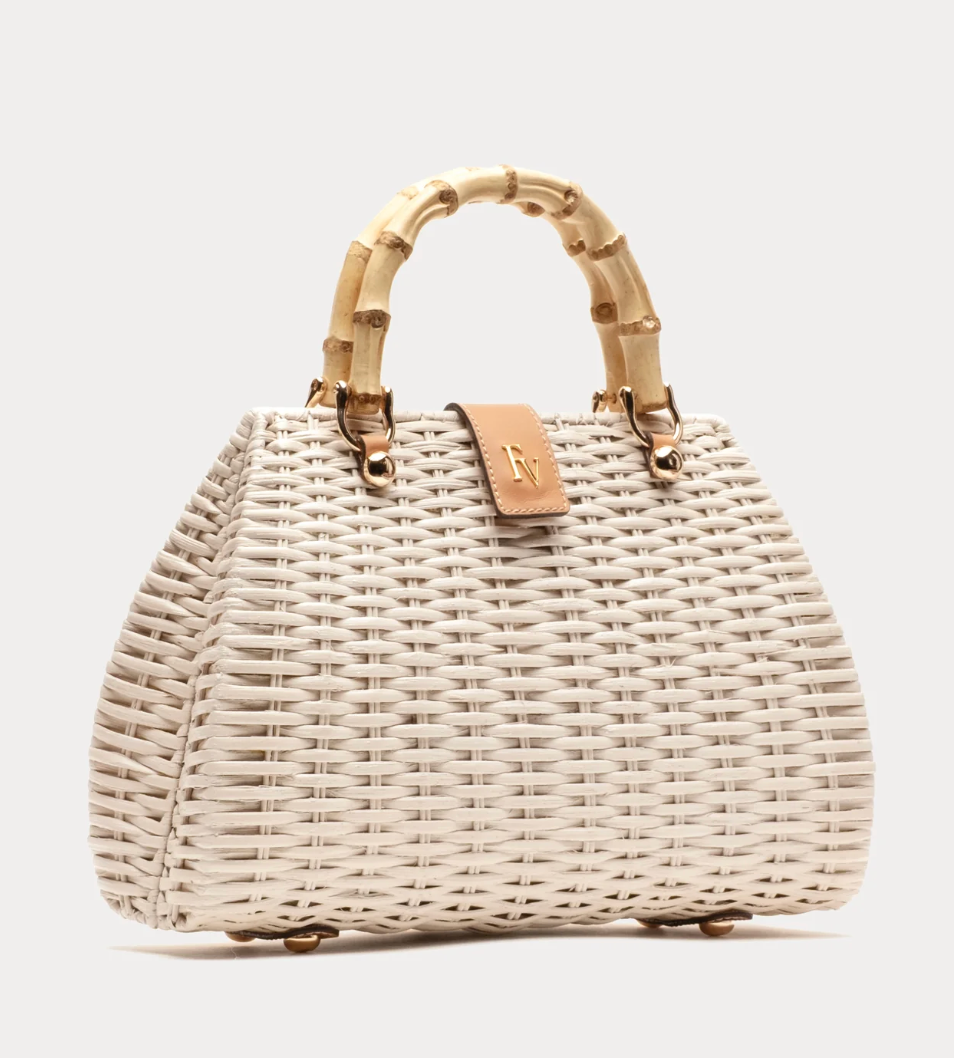 White woven handbag with bamboo handle on a light gray background