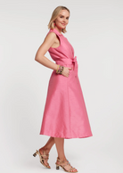 Woman wearing a pink dress on a white background