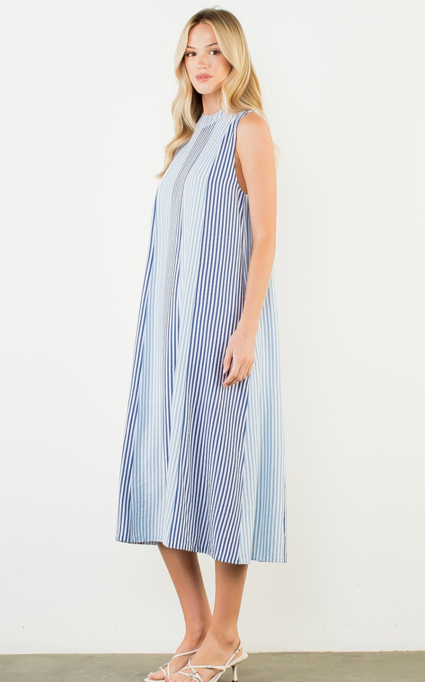 Woman wearing a blue and white striped dress on a white background