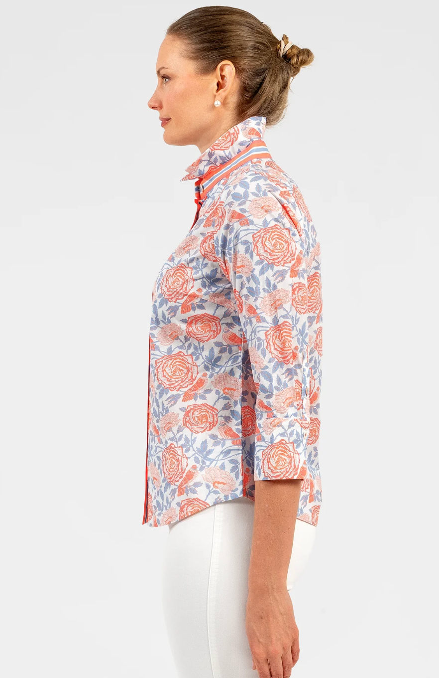 Woman wearing a patterned blouse with a white background