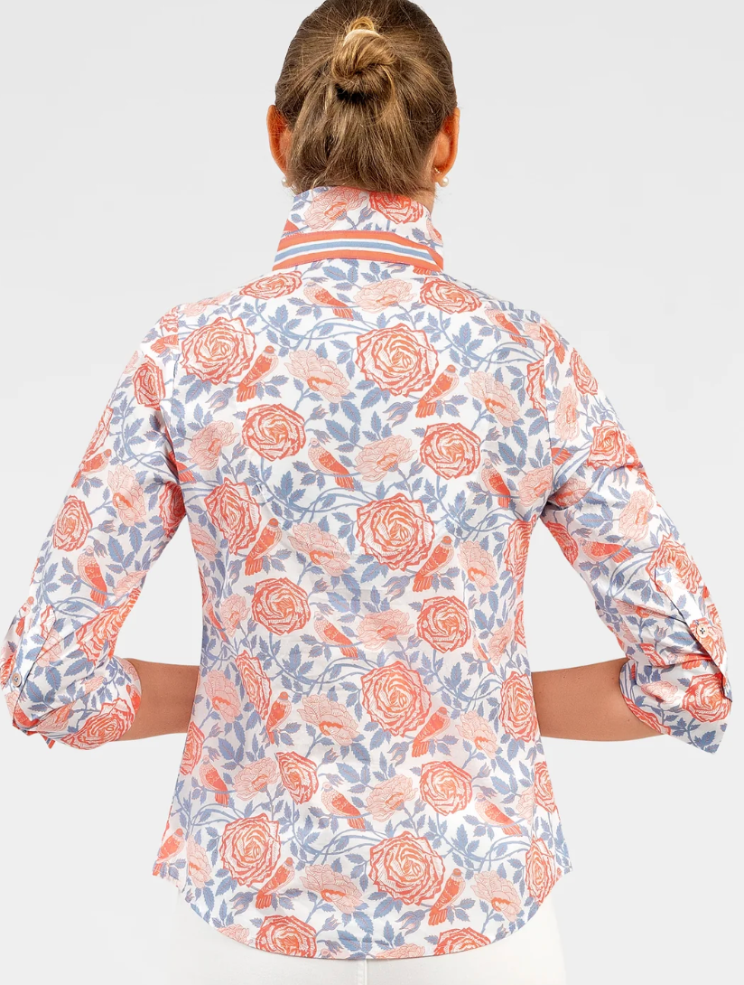 Floral patterned shirt worn by a person on a white background