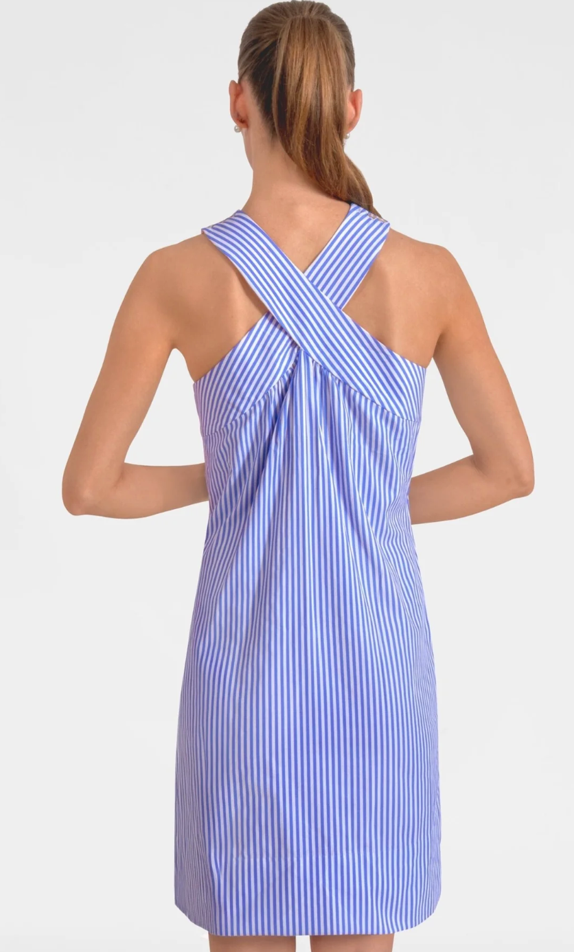 Woman wearing a blue and white striped dress with a criss-cross back design on a white background