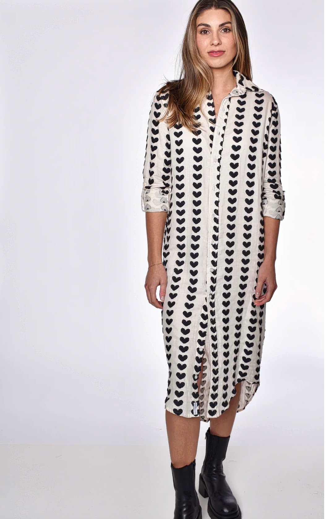 Woman wearing a black and white patterned dress on a white background