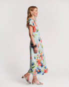 Woman wearing a floral dress on a plain background