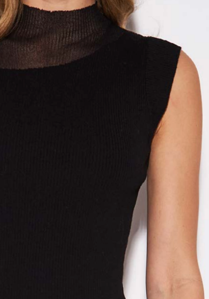 Close-up of a sleeveless black ribbed knit top with a sheer mesh mock neck collar, worn by a model against a plain white background.