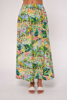 Person wearing a colorful floral skirt on a white background
