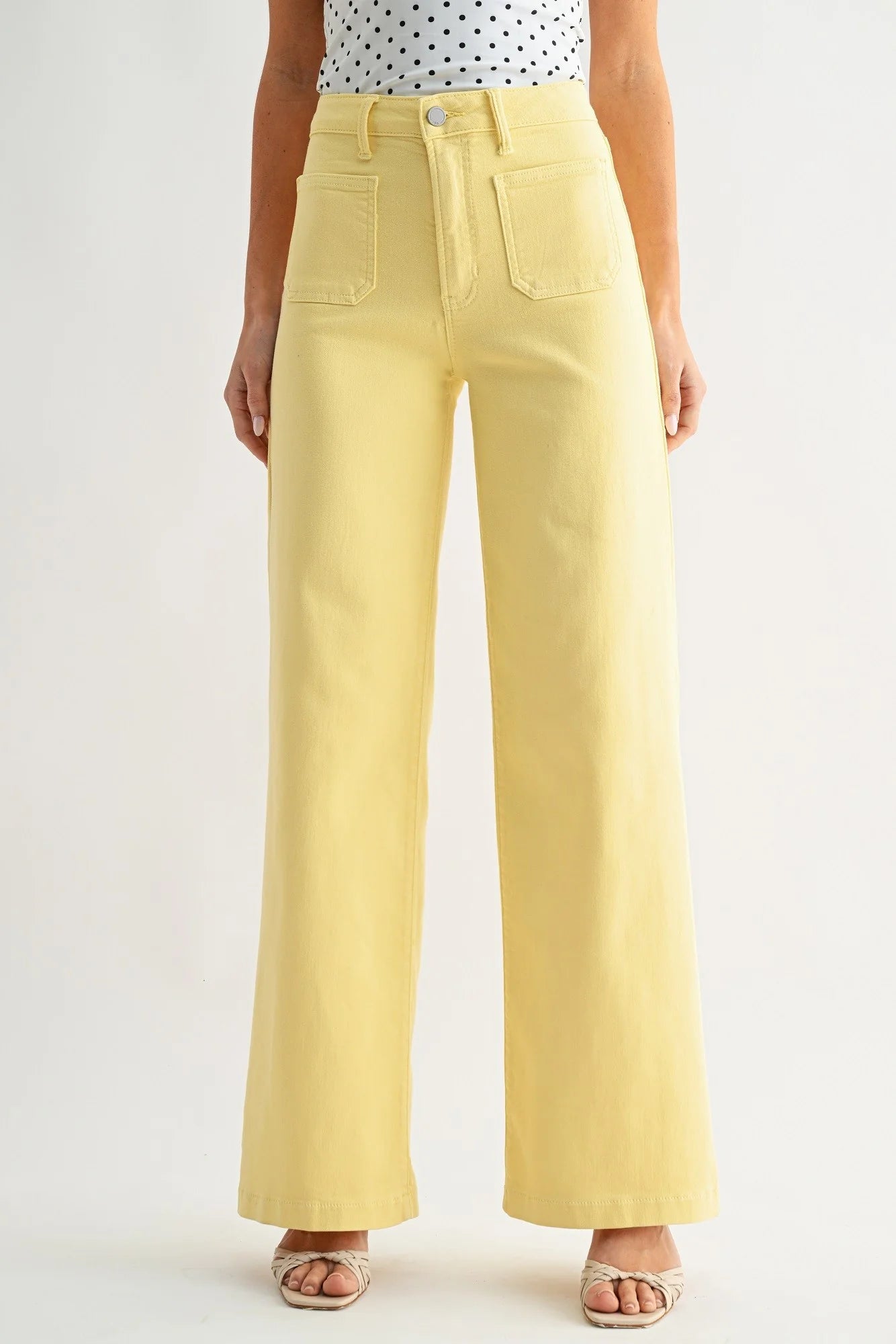 Yellow wide-leg pants worn by a person on a plain background