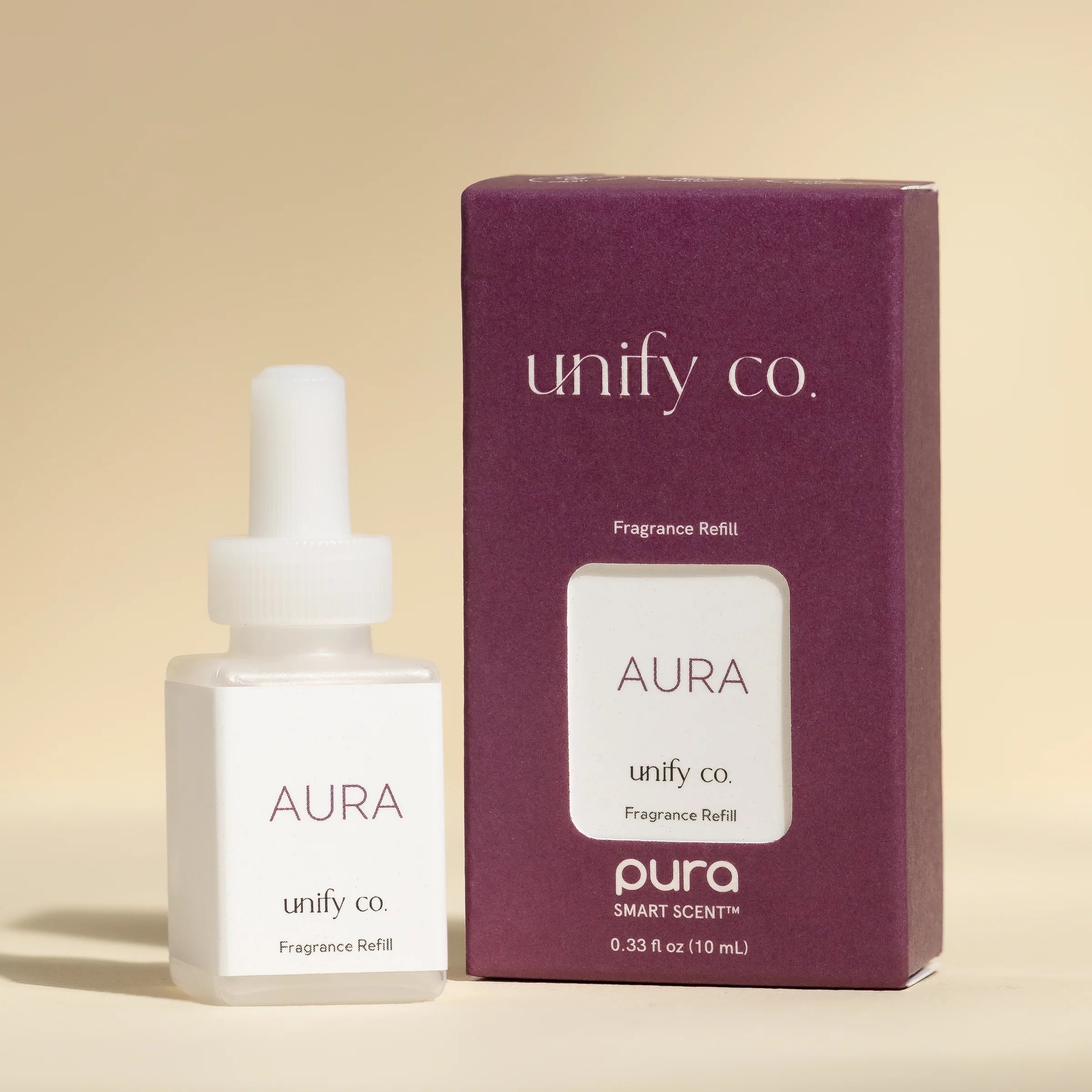 Aura fragrance refill bottle and packaging with 'unify co.' branding on a beige background