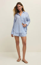 Woman wearing a light blue pajama set on a white background