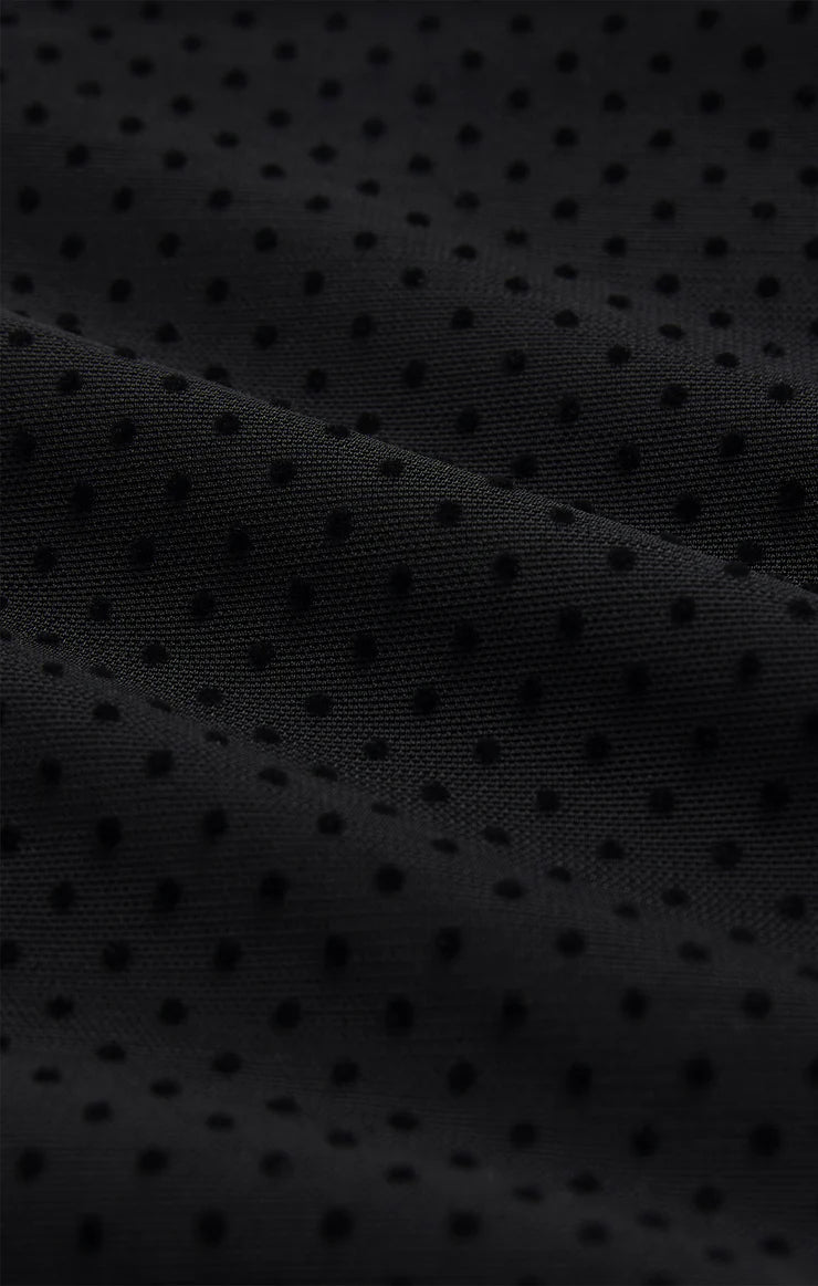 Close-up of black textured fabric with small dots