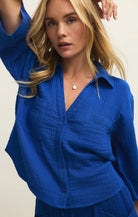 Woman wearing a blue outfit against a plain background