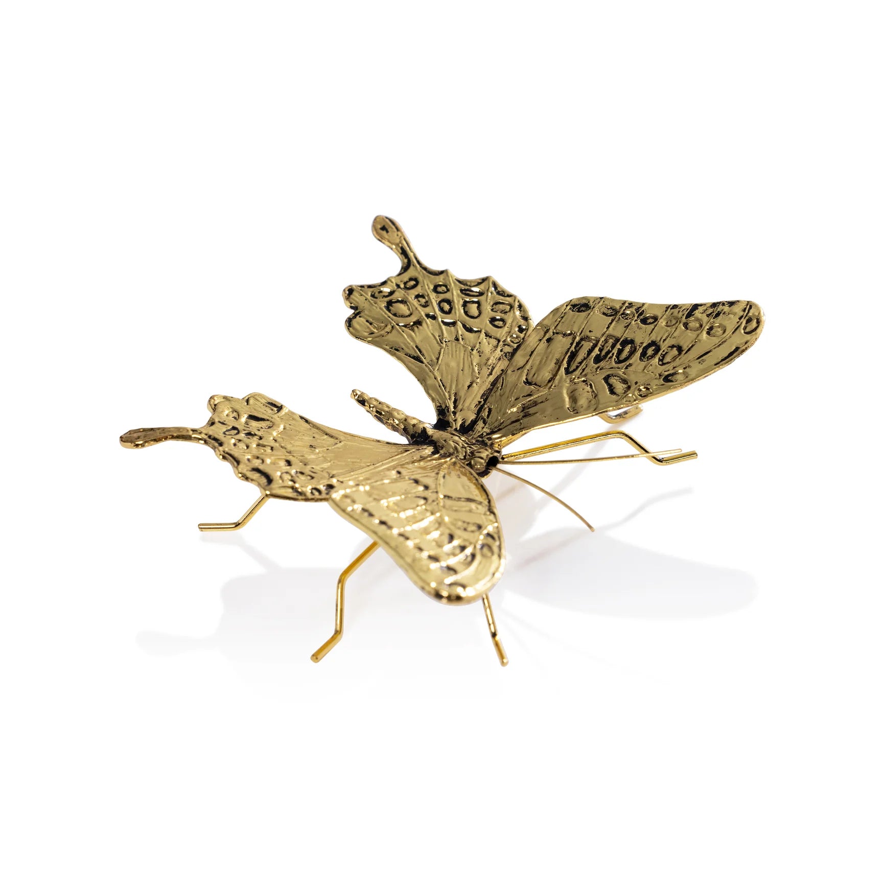 Gold butterfly-shaped object on a white background