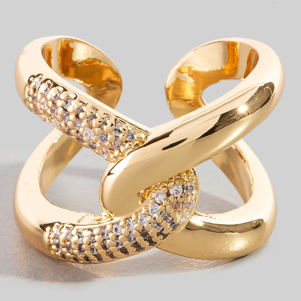 Gold ring with diamond accents on a light gray background