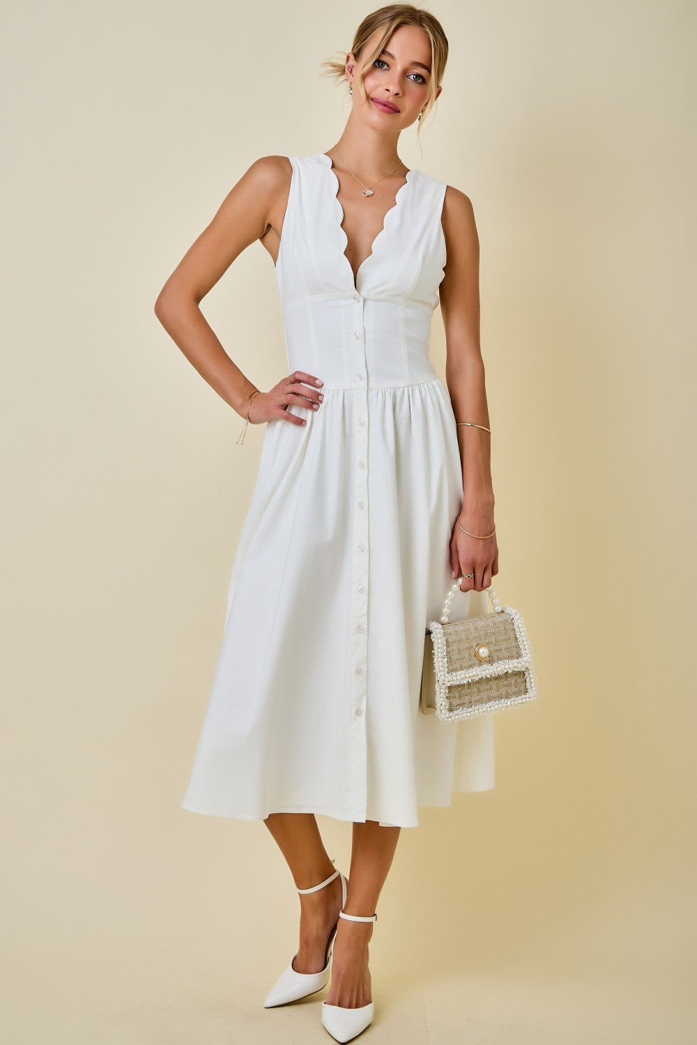 Woman wearing a white dress with a beige background