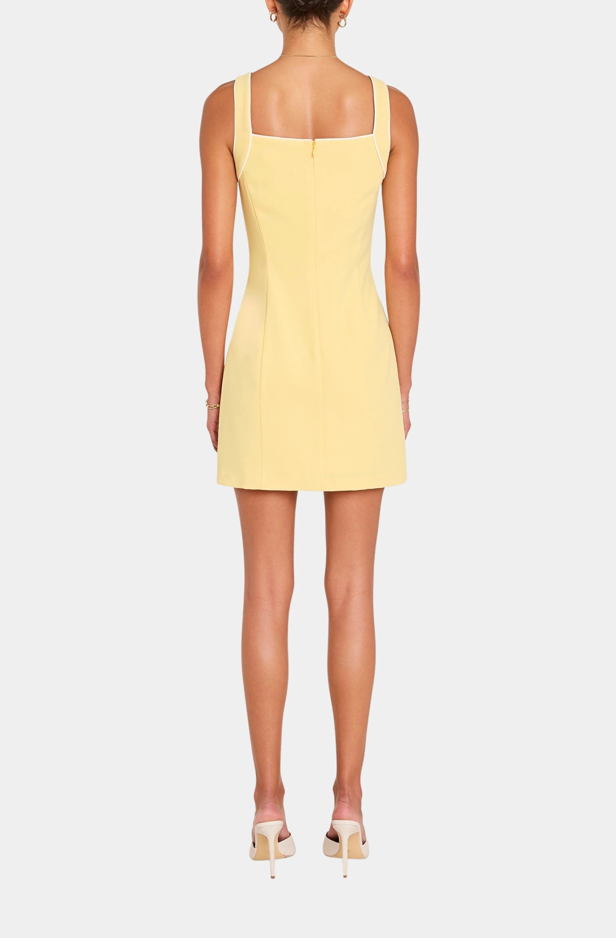 Yellow dress worn by a model on a white background
