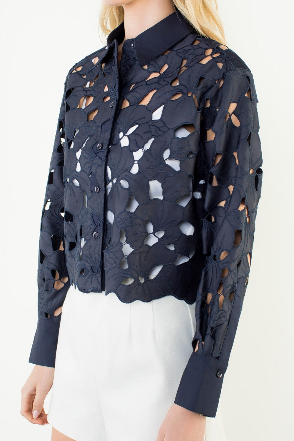 Navy blue perforated shirt worn by a model on a white background
