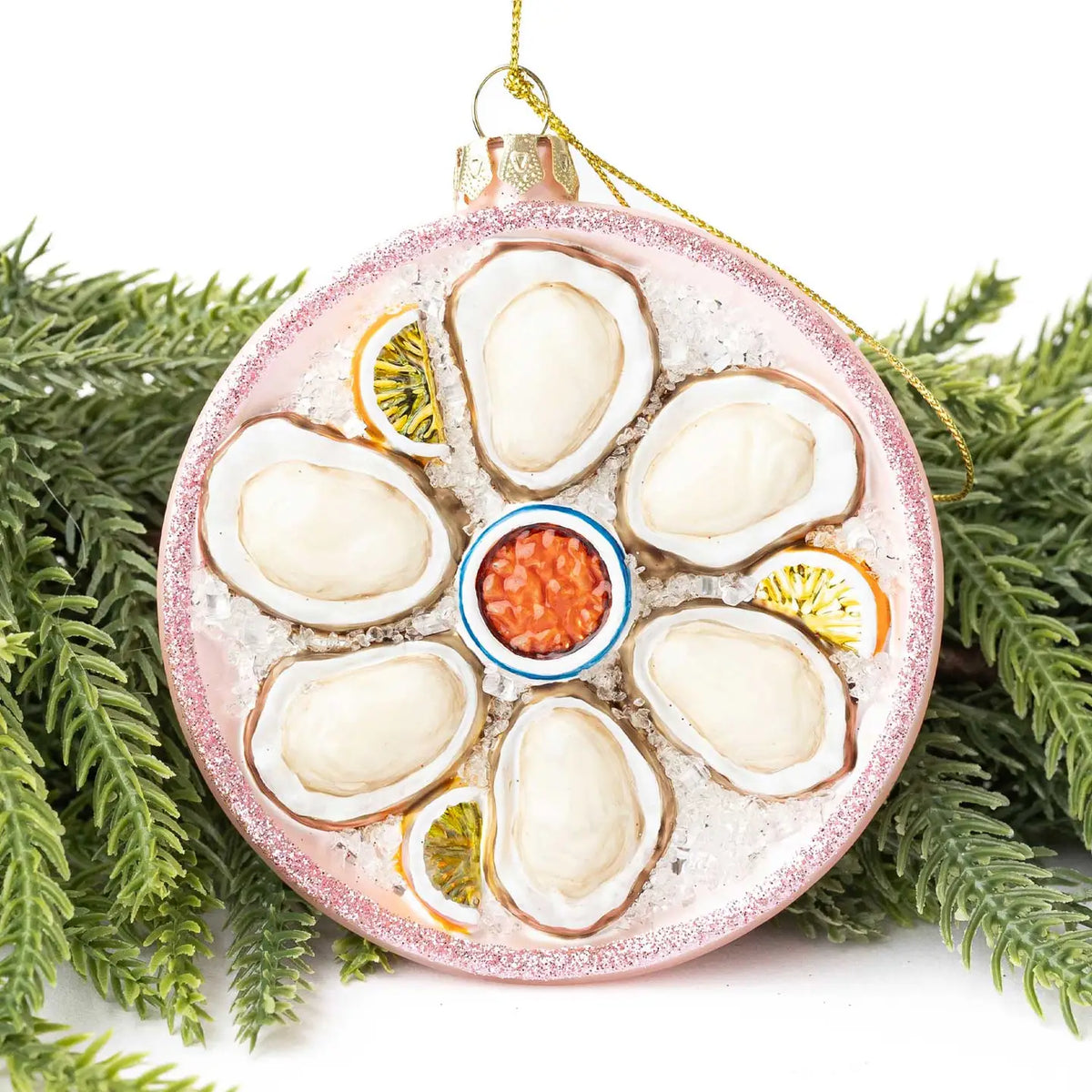Decorative ornament resembling a plate of oysters with garnishes on a white background