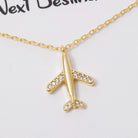 Gold airplane necklace with rhinestones on a white background