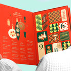 Open advent calendar with colorful designs and numbers on a red background
