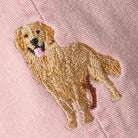 Embroidered golden retriever patch on a pink fabric background