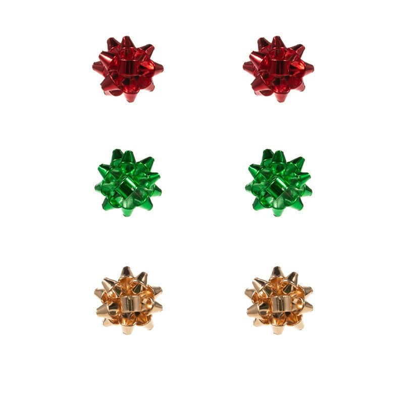 Set of festive earrings with red, green, and gold bows on a branded card.