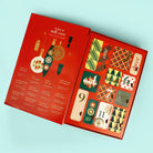 Red advent calendar with self-care items on a light blue background