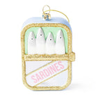 A sardine-shaped Christmas ornament featuring four white sardine bodies under a light blue lid, with glittery gold trim, a pale green interior, and a white lower section with pink 'SARDINES' text. A gold hanging loop is attached at the top.