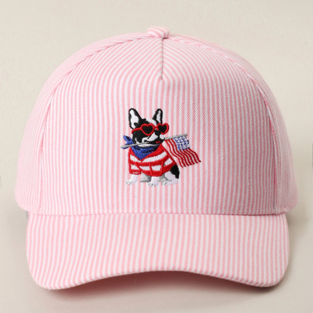 Pink cap with a dog wearing sunglasses and an American flag design on a beige background