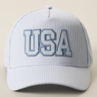 Light blue cap with 'USA' embroidery on a beige background