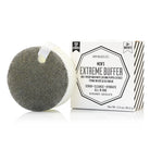 A round sponge body wash with a gray scrubbed exterior and white core, shown next to its white packaging box labeled 'Spongullé Men's Extreme Buffer' on a clean white background.