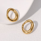 Gold earrings on a white background