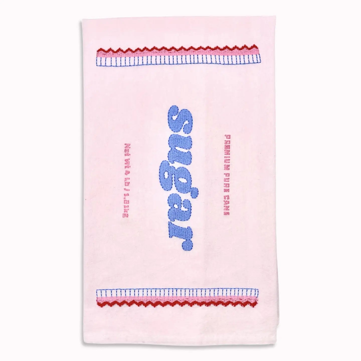A light pink tea towel featuring a retro sugar-themed design with blue and red embroidered details.