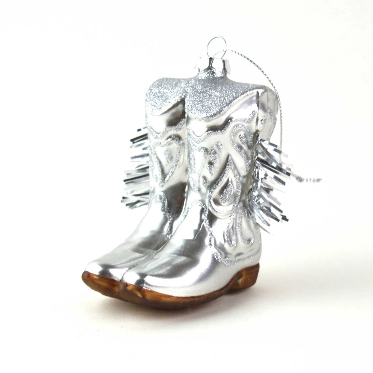 Silver cowboy boot ornament on a white background