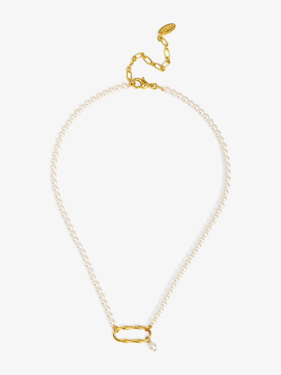 Pearl necklace with gold clasp on a white background