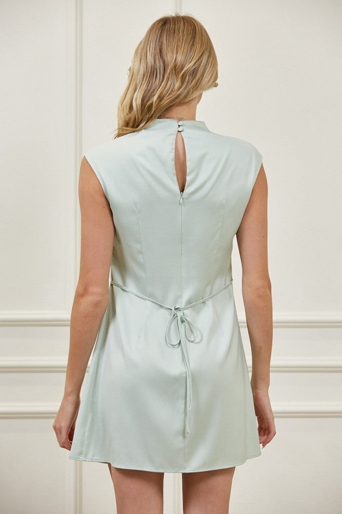 Light green dress worn by a person on a white background