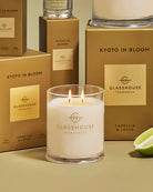 Glasshouse Fragrances candle with boxes in the background
