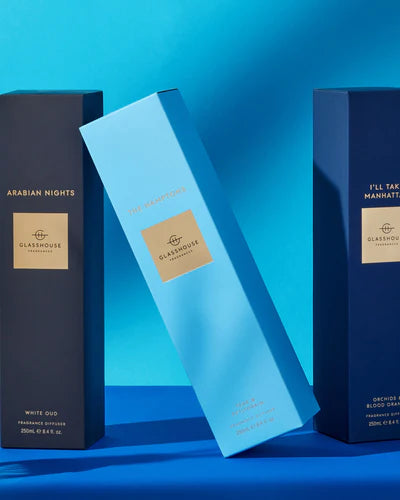 Three Glasshouse Fragrances boxes on a blue background