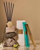 Aromatherapy diffuser with reeds, stones, and a box on a beige background