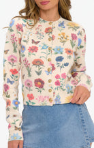 Woman wearing a floral patterned blouse with a white background