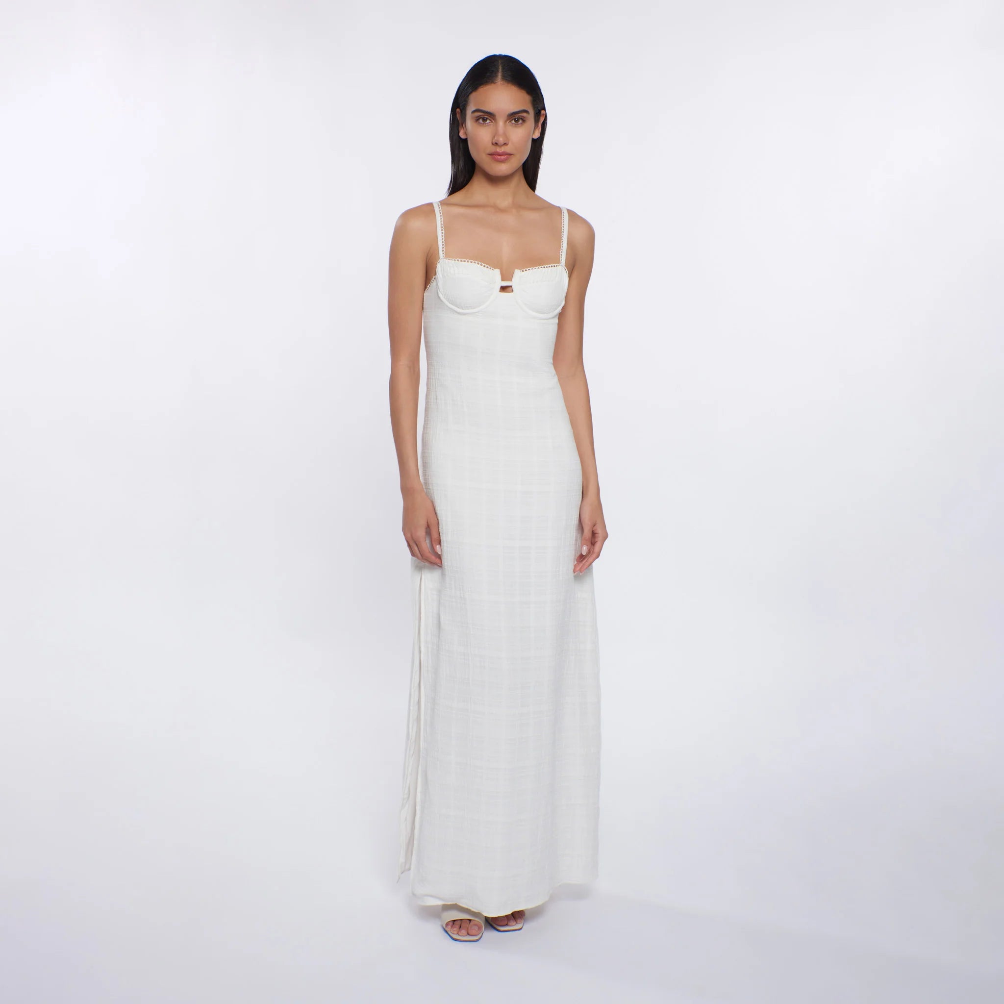 Woman wearing a white dress on a white background