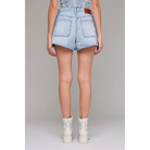 Light blue denim shorts worn by a person on a plain background