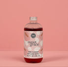 Sweet Grace pink flower diffuser refill bottle on a pink background