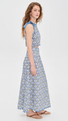Woman wearing a blue patterned dress on a white background
